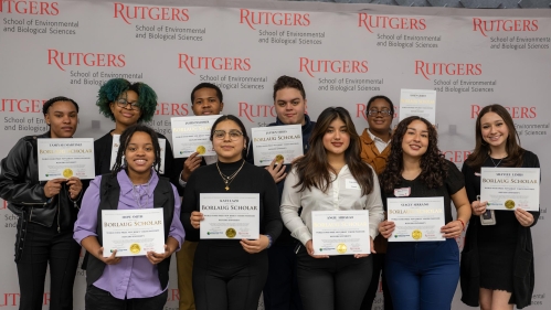 A group of high school students holding certificates.