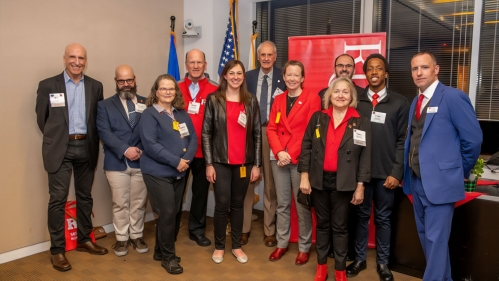 A group of alumni standing with the Executive Dean.
