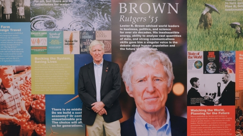 Lester R. Brown standing in the Lester R. Brown Reading Room.