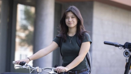 A student on a bike.