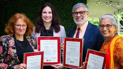 Four faculty members holding awards.