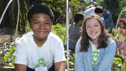 A 4-H'er and a 4-H Volunteer working in a garden.