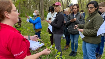 Rutgers Environmental Steward participants identifying trees outdoors.