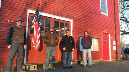 Four people standing in front of a building at Hort Farm 3.