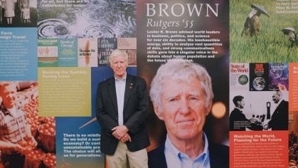 Lester R. Brown standing in the Lester R. Brown Reading Room.