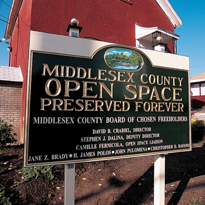 A sign that reads, 'Middlesex County Open Space - Preserved Forever'.