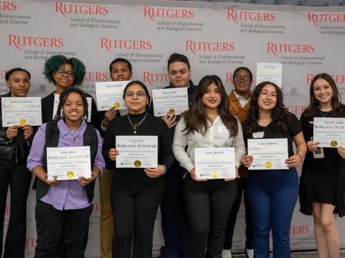 A group of high school students holding certificates.