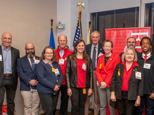 A group of alumni standing with the Executive Dean.